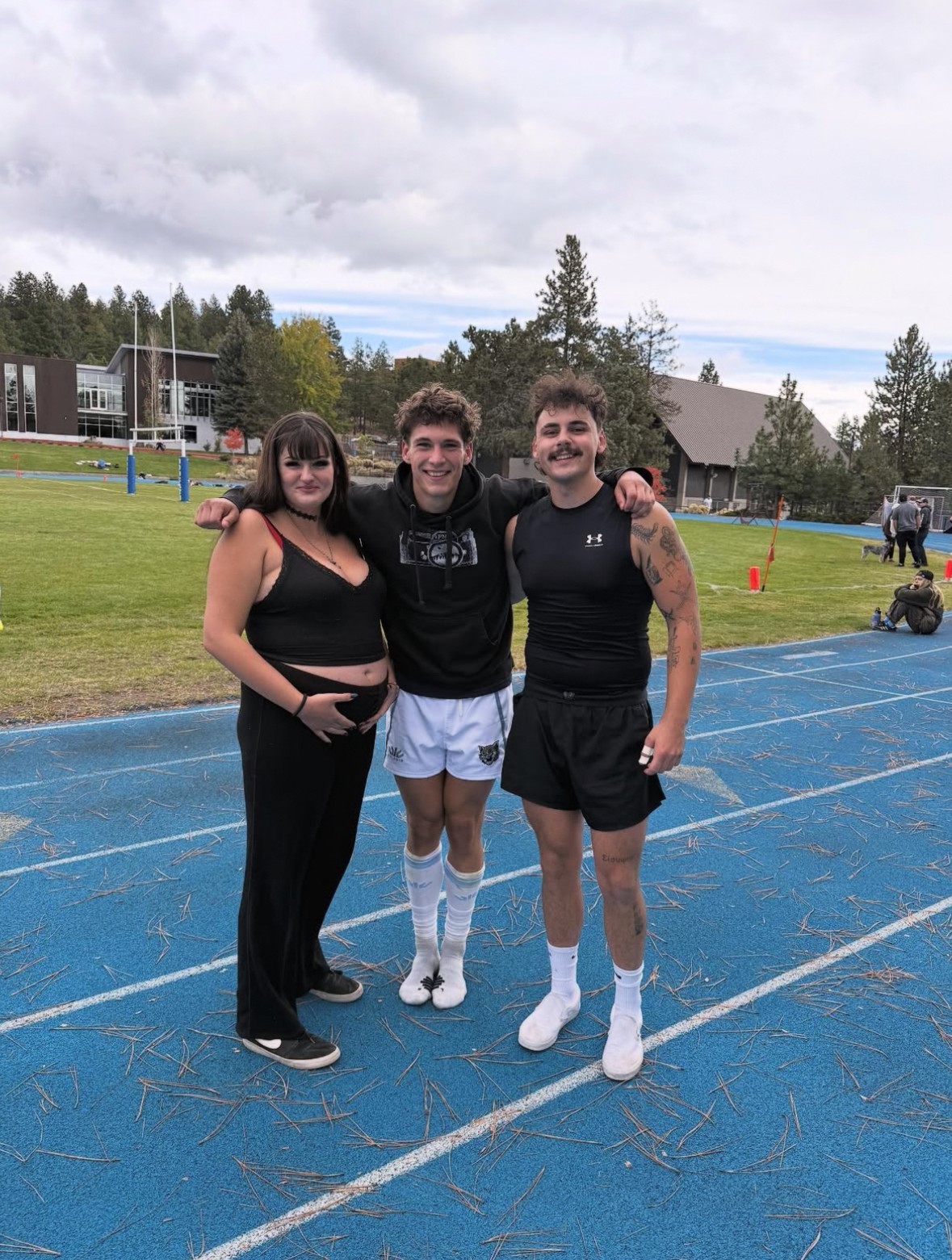 My brother and I in arms with our little sister and soon to be nephew!